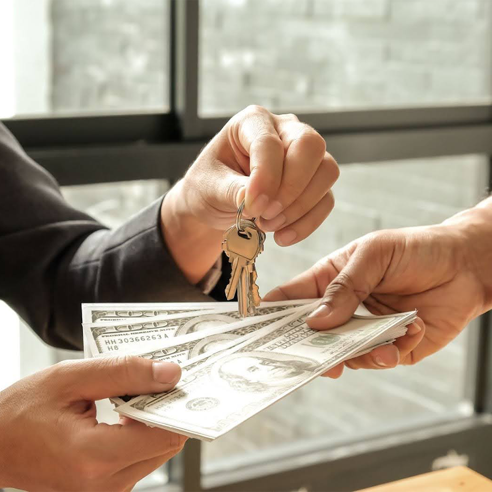 Exchange of house keys for cash in a real estate transaction.